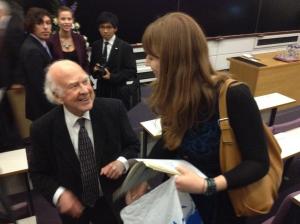 Professor Higgs just after he had signed my NYT newspaper of the discovery of the Higgs boson at CERN. Photo credit: S.Marsden. (Also, note I'm not a giant, just  on the stairs)